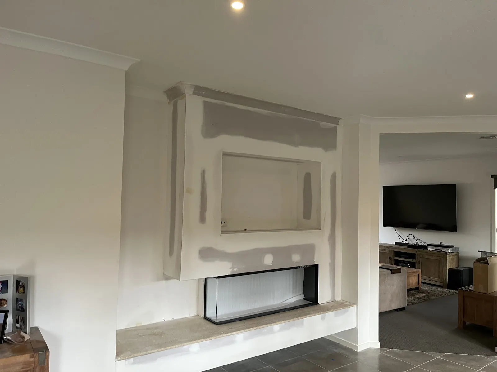 Newly plastered room showing flat, paint-ready surfaces.